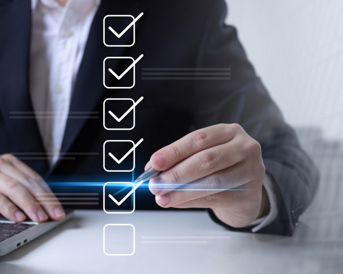 Businessman ticks online checklist.