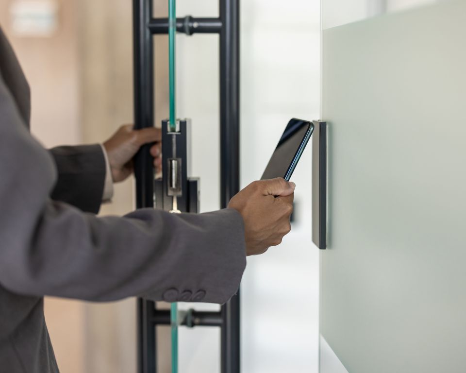 Business professional using smartphone for secure access to modern office building