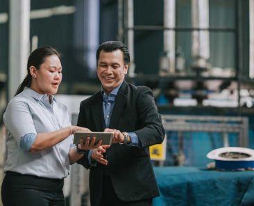 Woman and man managing systems in warehouse