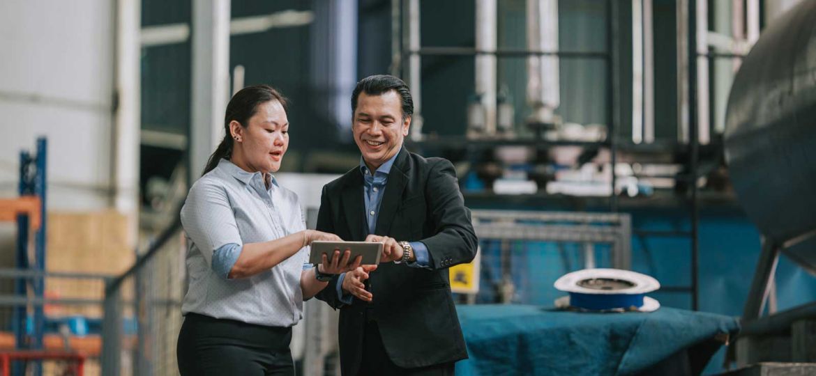 Woman and man managing systems in warehouse